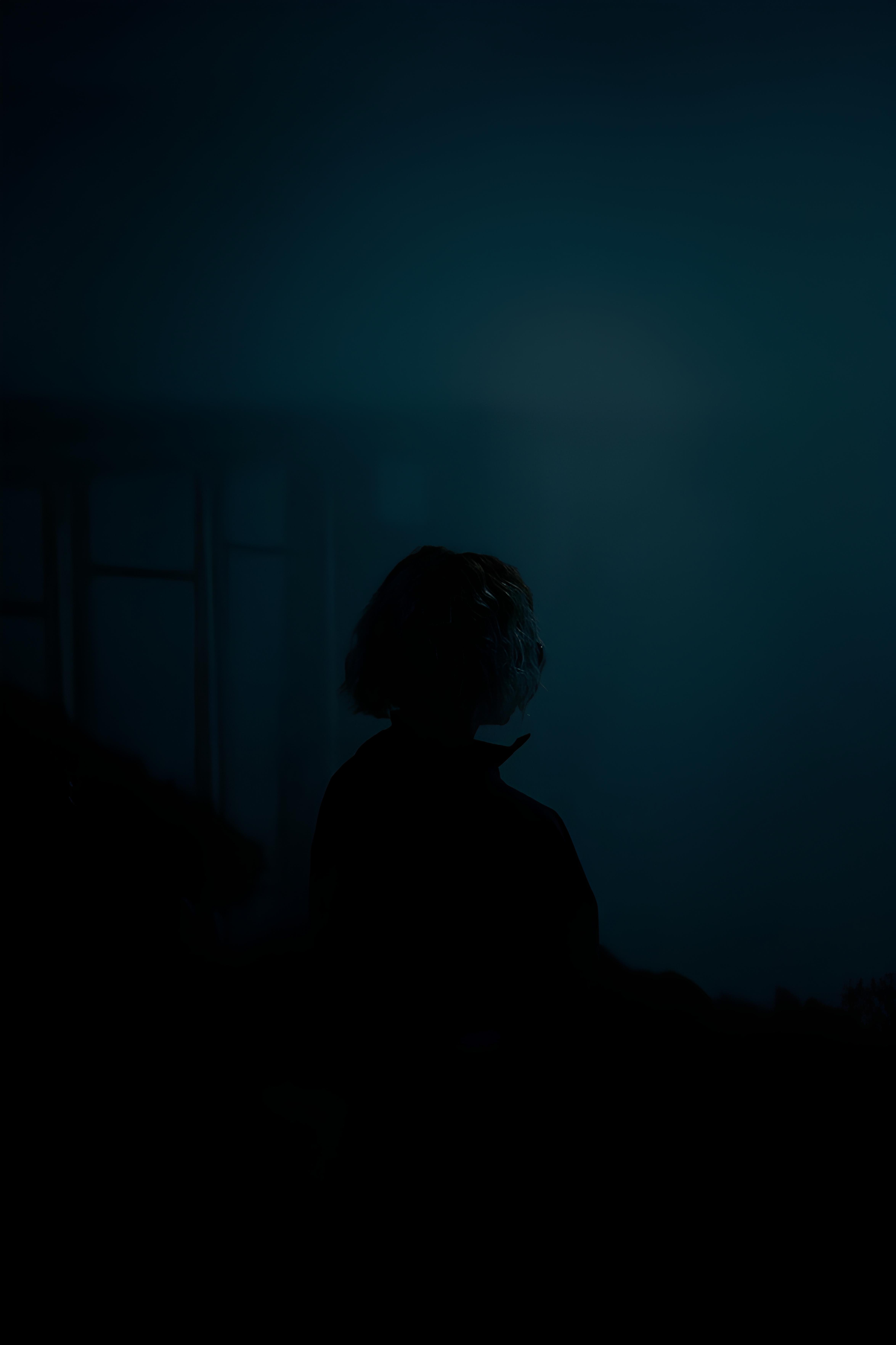 mentally exhausted but not lazy emotional fatigue conceptmentally exhausted person standing in dark room with light from window showing emotional and mental fatigue