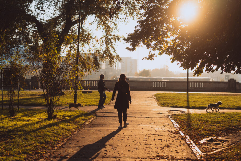 person on a slow morning walk through neighbourhood looking relaxed and unhurried